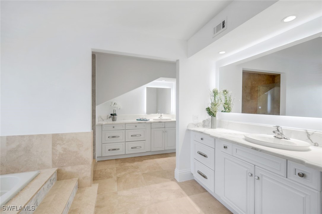 513 Lighthouse Way Sanibel, FL 33957 - Photo 27 of 44 a spacious bathroom with a granite countertop sink mirror and