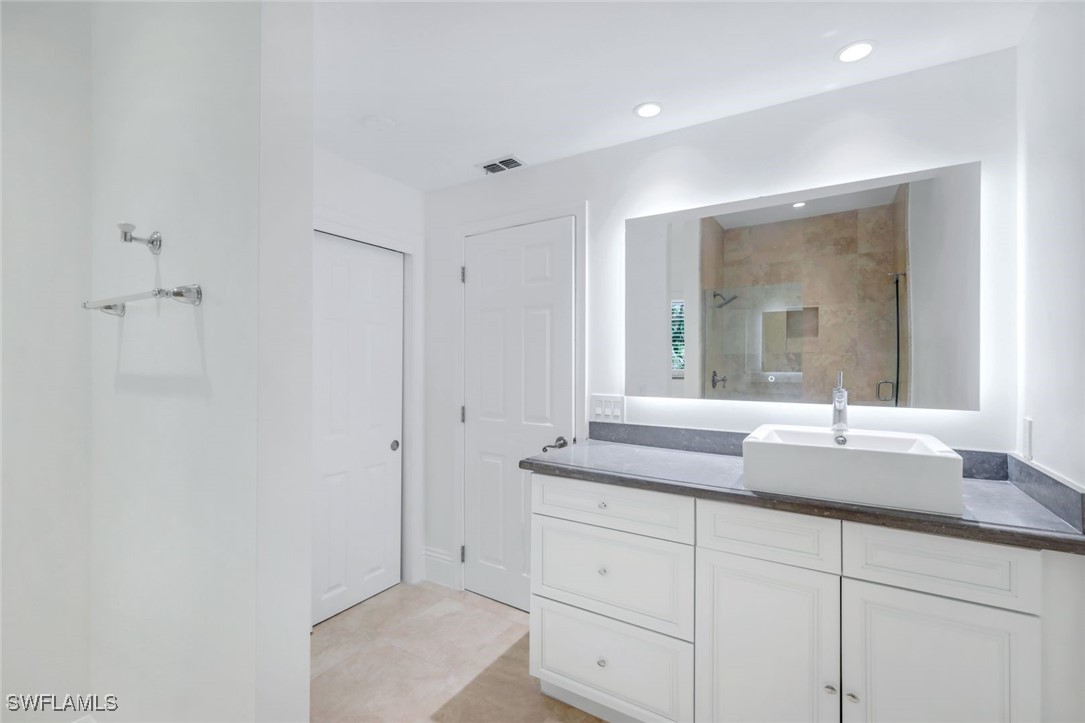 513 Lighthouse Way Sanibel, FL 33957 - Photo 33 of 44 a bathroom with a granite countertop sink mirror and cabinets