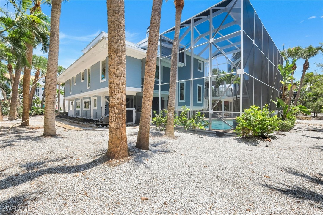 513 Lighthouse Way Sanibel, FL 33957 - Photo 43 of 44 a view of a house with a yard and pathway