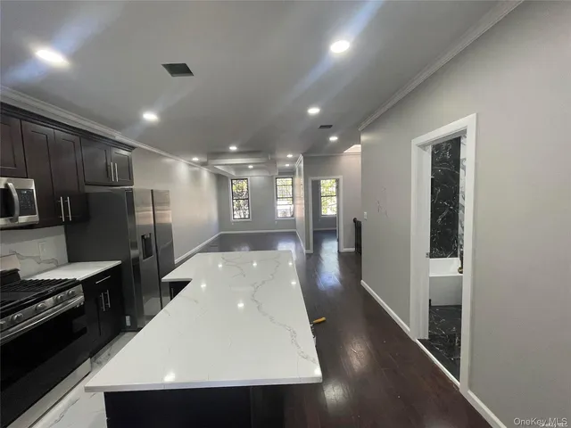 a kitchen with stainless steel appliances a refrigerator and a stove top oven