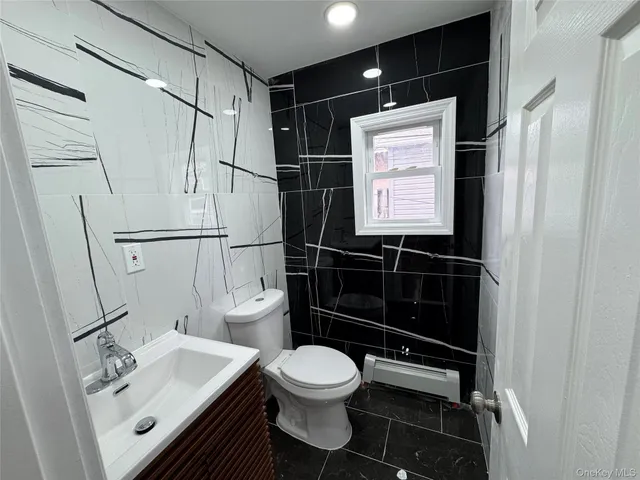 a bathroom with a toilet a sink and a shower