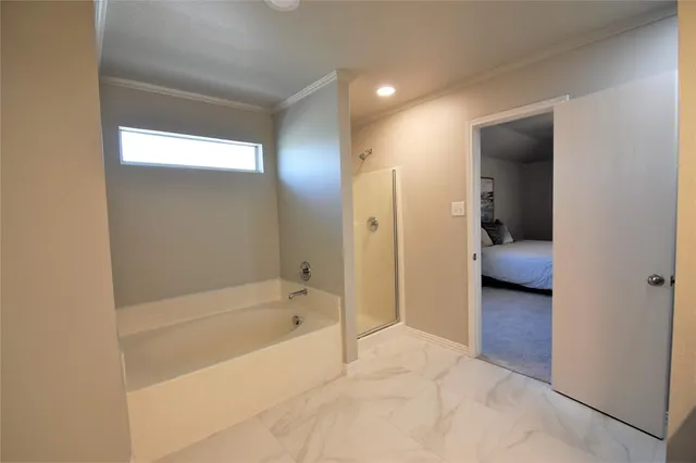 a en suite bathroom with a bathtub and a toilet