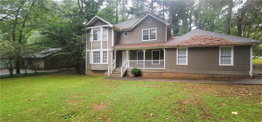 800 Post Rd Circle Stone Mountain, GA 30088 - Photo 1 of 1 a front view of a house with a garden and yard