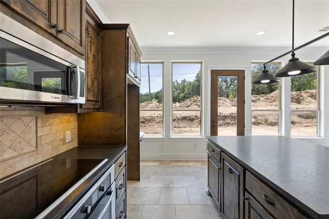 a kitchen with stainless steel appliances a stove sink and microwave