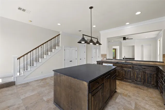 a kitchen that has a sink a stove and a table