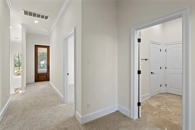 a view of a hallway with an entryway door