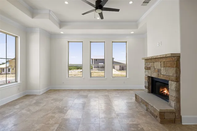 a view of an empty room with a fireplace and a window