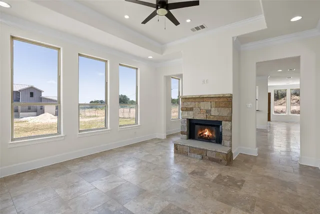 a view of an empty room with window and fire place