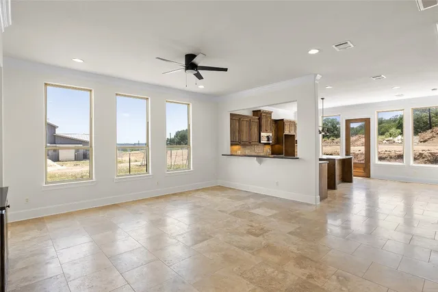 a view of livingroom with a window and a kitchen