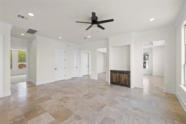 an empty room with cabinet and a ceiling fan