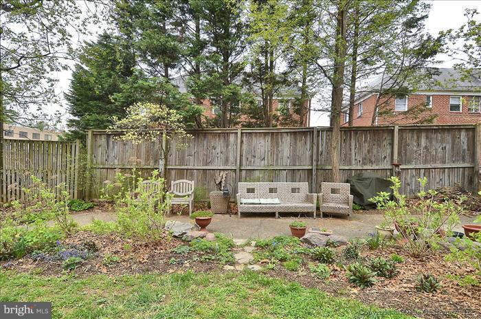 8708 Bradford Road, Unit 301 Silver Spring, MD 20901 - Photo 12 of 13 a view of a garden with a bench