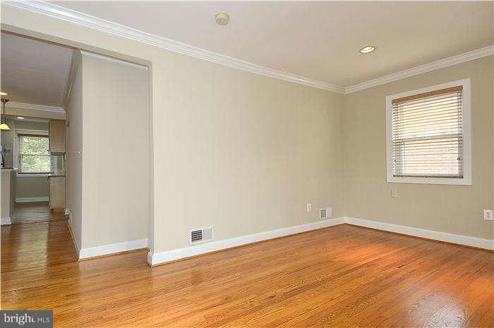 8708 Bradford Road, Unit 301 Silver Spring, MD 20901 - Photo 6 of 13 wooden floor in an empty room with a window