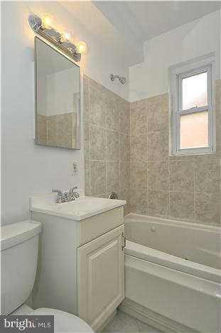 8708 Bradford Road, Unit 301 Silver Spring, MD 20901 - Photo 7 of 13 a bathroom with a sink a toilet and shower
