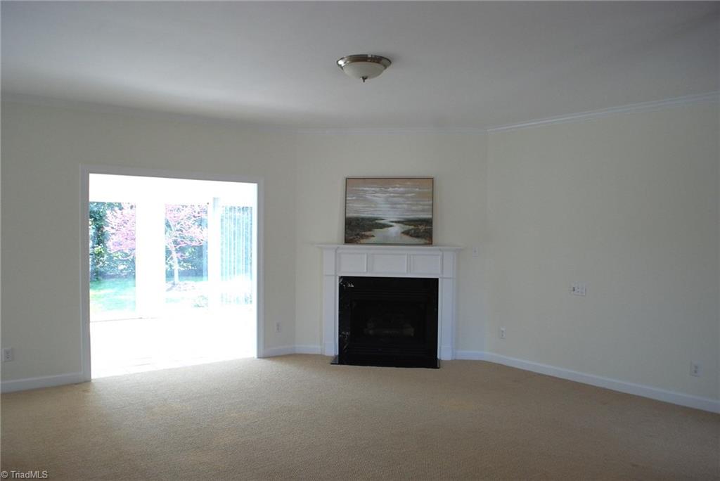 5301 Ridge Trail Road Summerfield, NC 27358 - Photo 3 of 30 Great room features a gas log fireplace & is open to the sunroom.