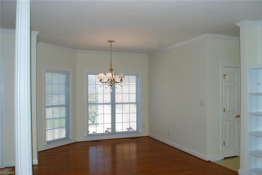 5301 Ridge Trail Road Summerfield, NC 27358 - Photo 4 of 30 Elegant dining room with new chandelier & hardwood flooring.