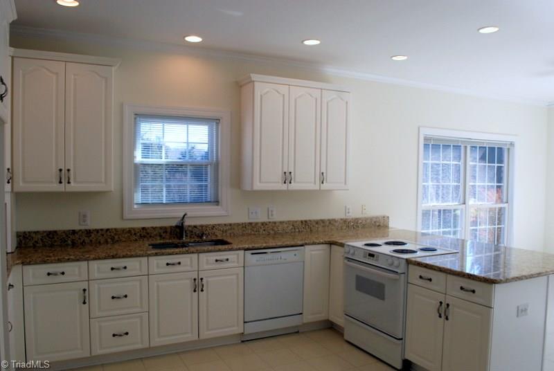 5301 Ridge Trail Road Summerfield, NC 27358 - Photo 8 of 30 Elegant all white kitchen features new granite counter tops & recessed lighting.