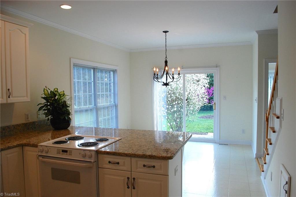 5301 Ridge Trail Road Summerfield, NC 27358 - Photo 9 of 30 All white light & bright kitchen with granite countertops.