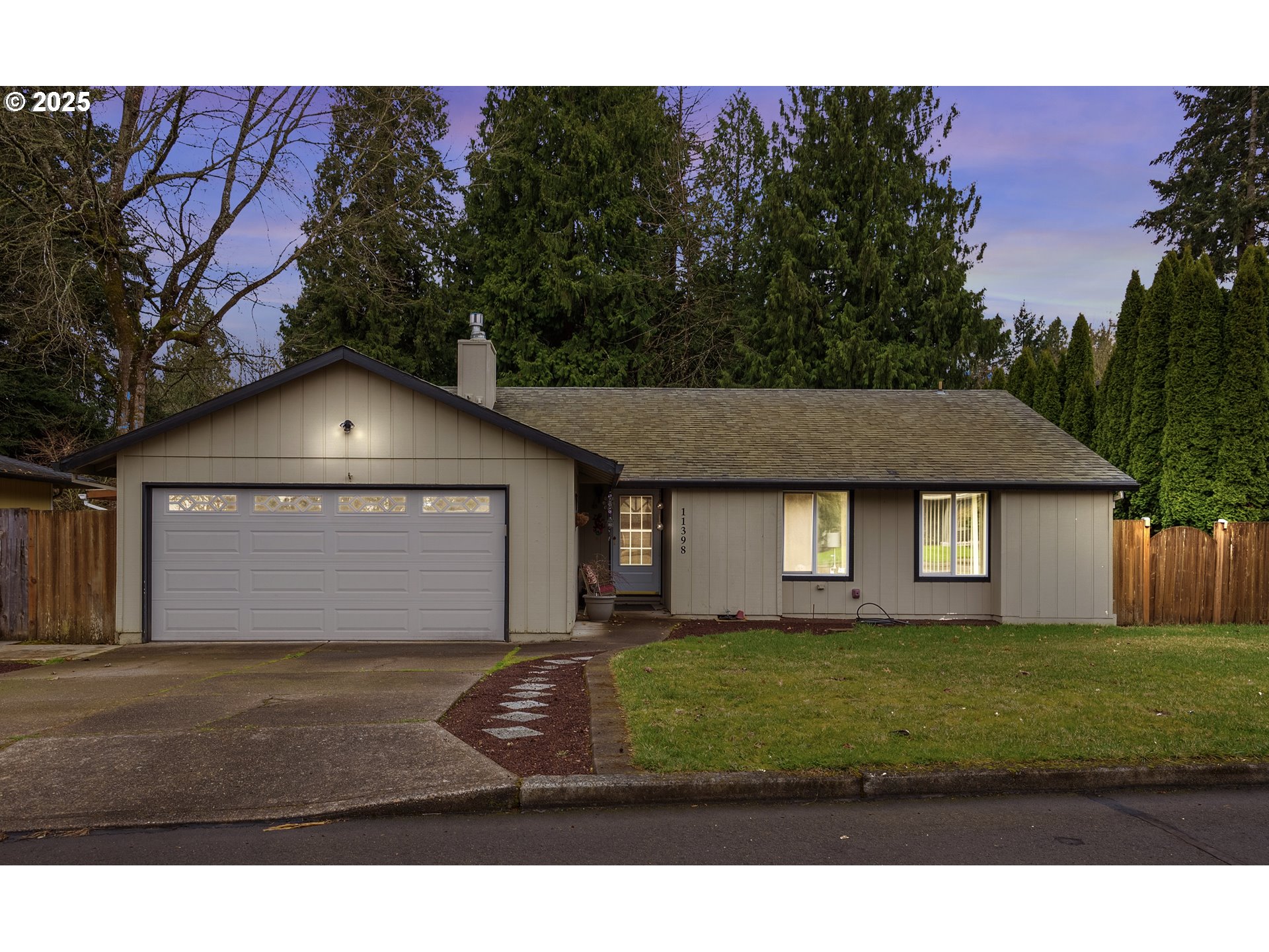 11398 Southwest Ironwood Loop Portland, OR 97223 - Photo 1 of 44 a front view of a house with a yard and garage