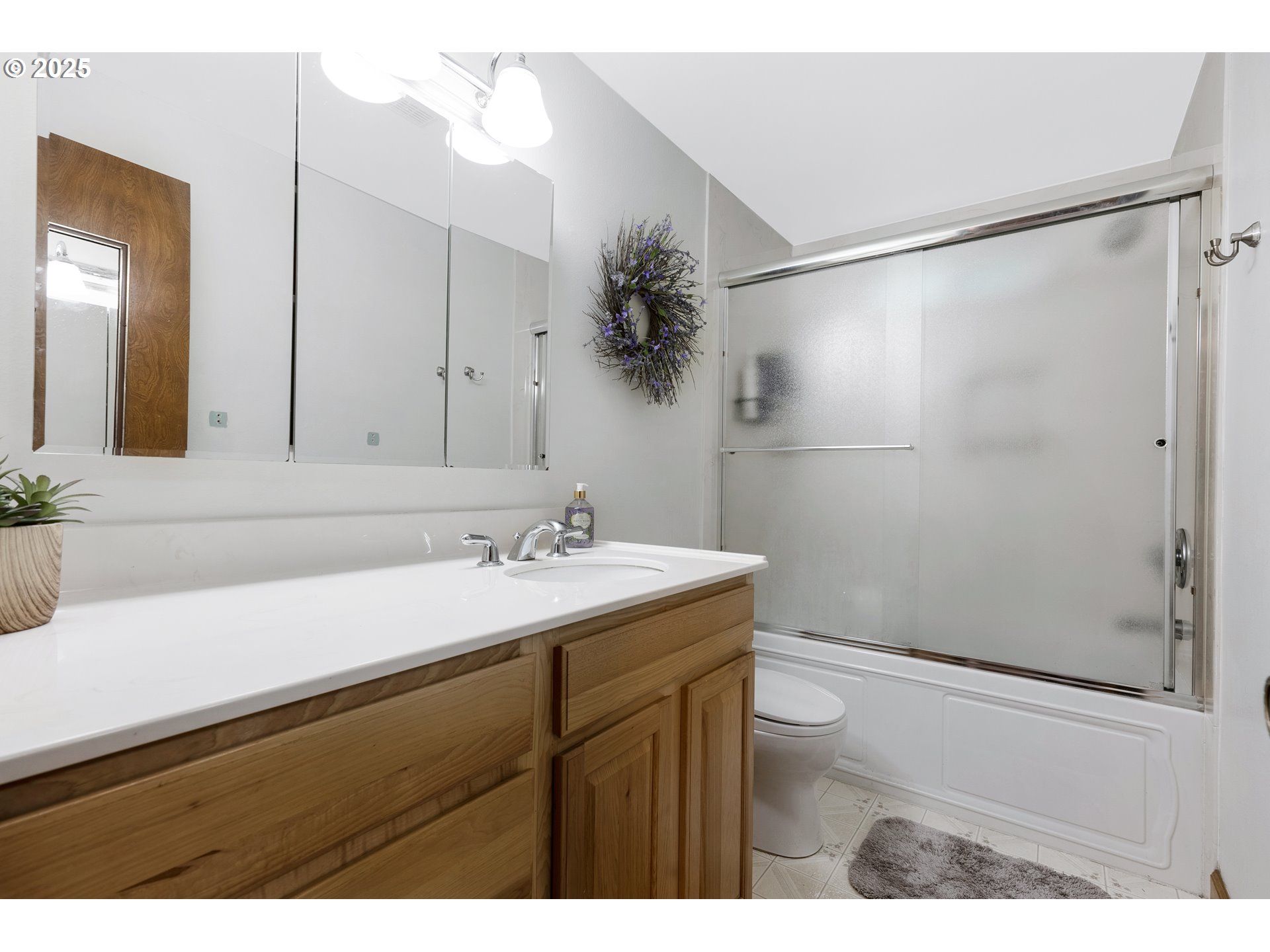 11398 Southwest Ironwood Loop Portland, OR 97223 - Photo 17 of 44 a bathroom with a sink and mirror