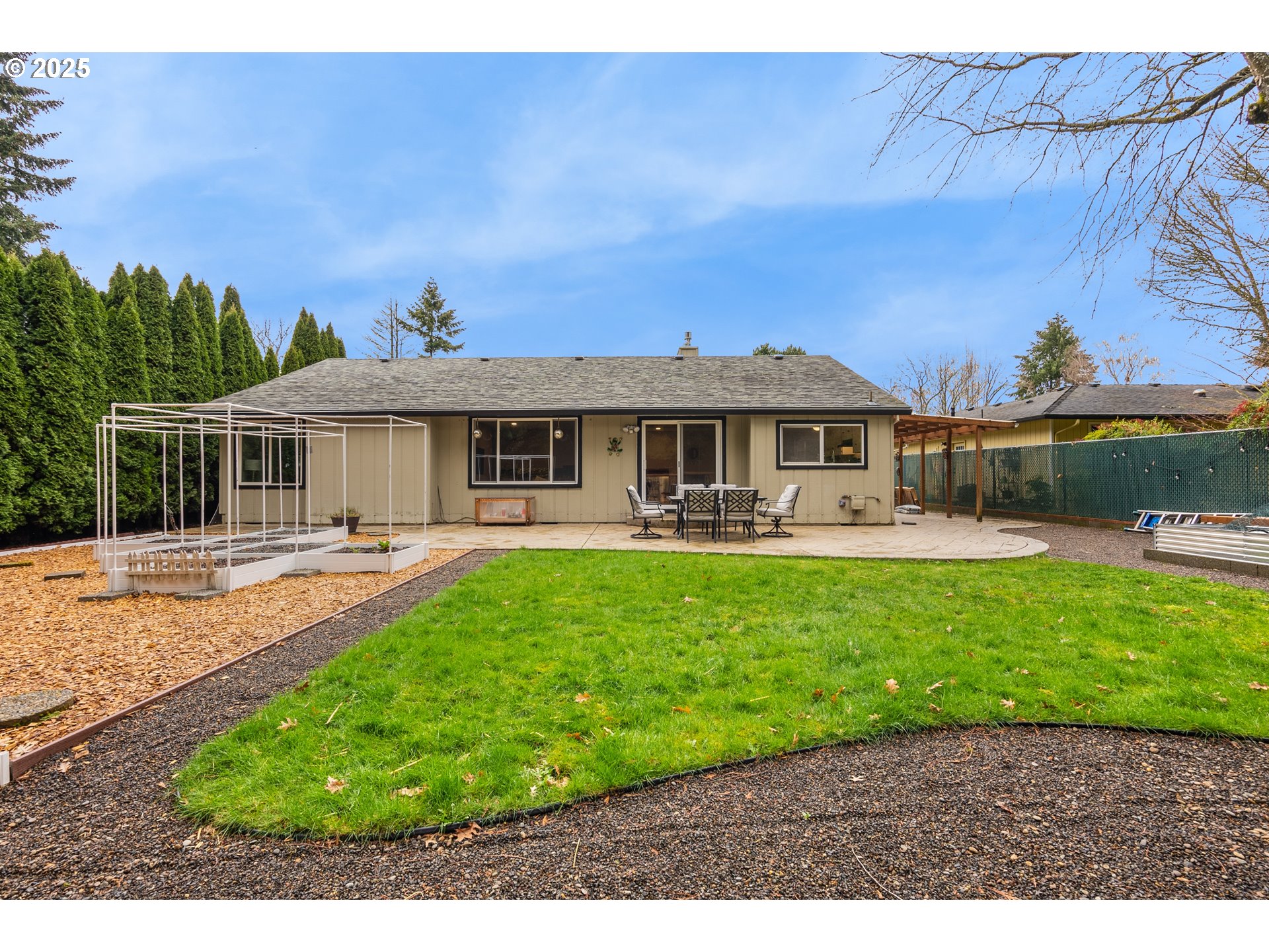 11398 Southwest Ironwood Loop Portland, OR 97223 - Photo 34 of 44 a front view of a house with a yard table and chairs