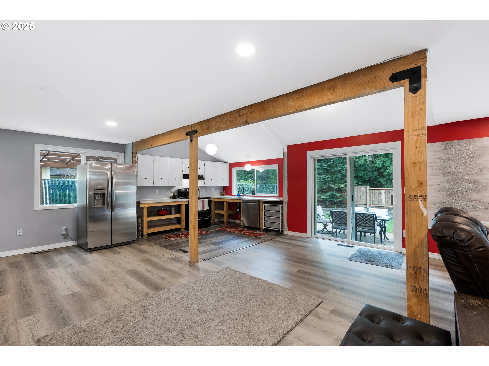 11398 Southwest Ironwood Loop Portland, OR 97223 - Photo 6 of 44 a living room with furniture a flat screen tv and floor to ceiling window