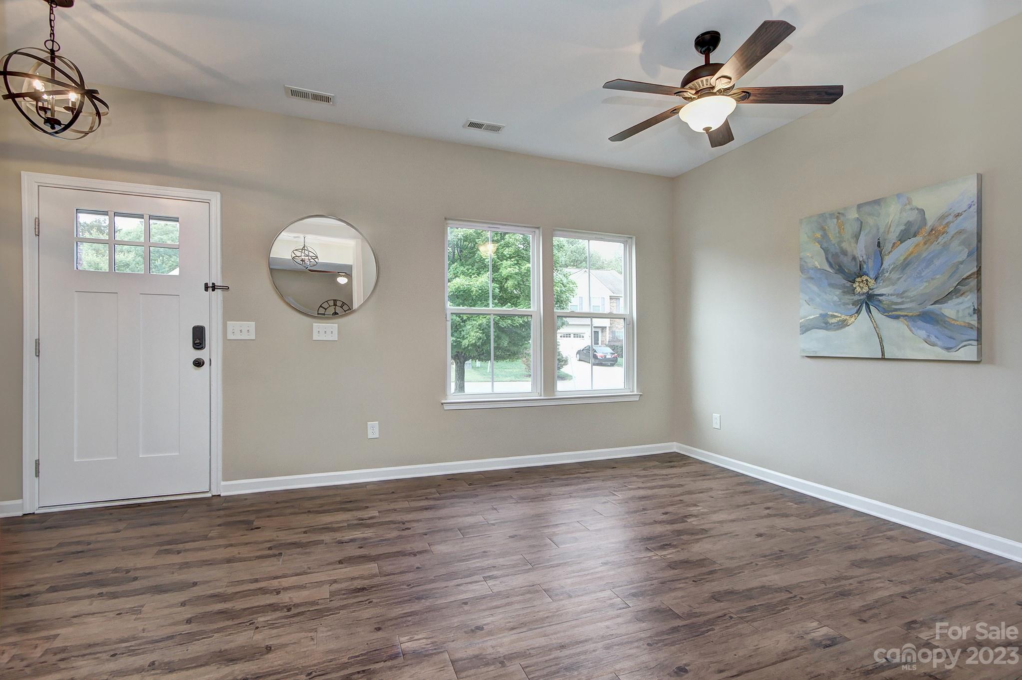 3071 Rhododendron Place Clover, SC 29710 - Photo 4 of 34 a view of an empty room with wooden floor and window