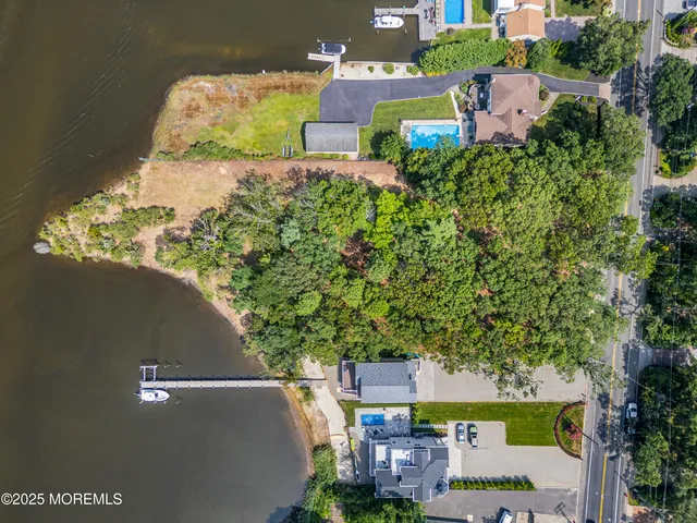 an aerial view of a house with a yard basket ball court and outdoor seating