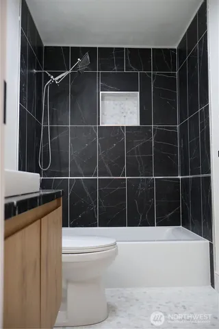 a bathroom with a toilet a sink a shower and bathtub