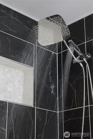 a bathroom with a shower and a mirror