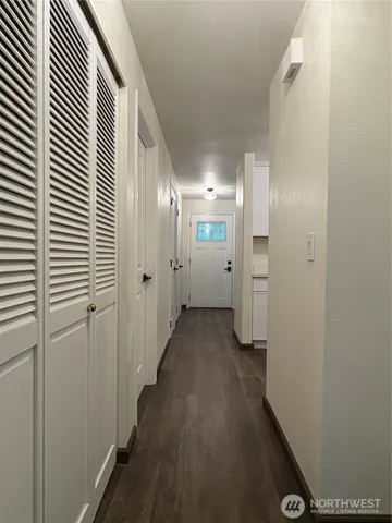 a view of a hallway with wooden floor
