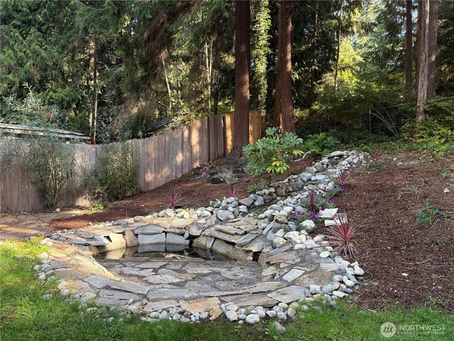 a view of a yard with large trees