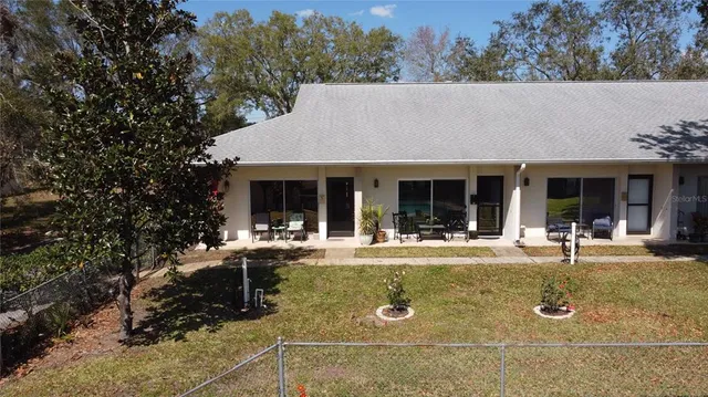 front view of house with a chairs and table in a patio