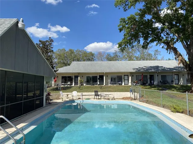 a view of a house with backyard porch and sitting area