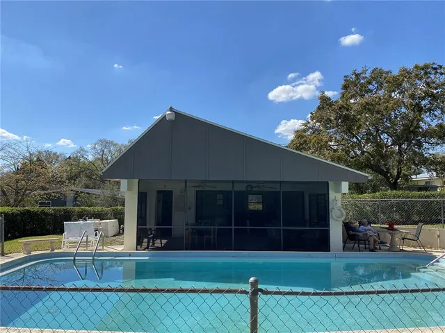 a view of a house with a yard and sitting area