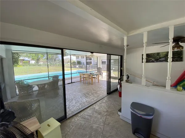 a living room with furniture and a floor to ceiling window