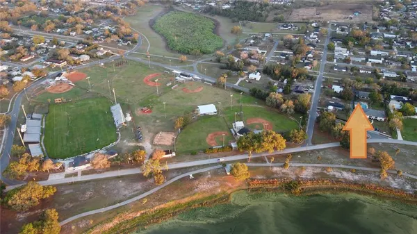 an aerial view of a house with a yard