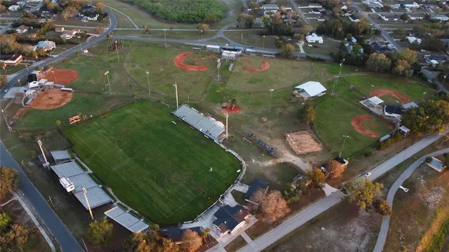 an aerial view of a residential houses with outdoor space