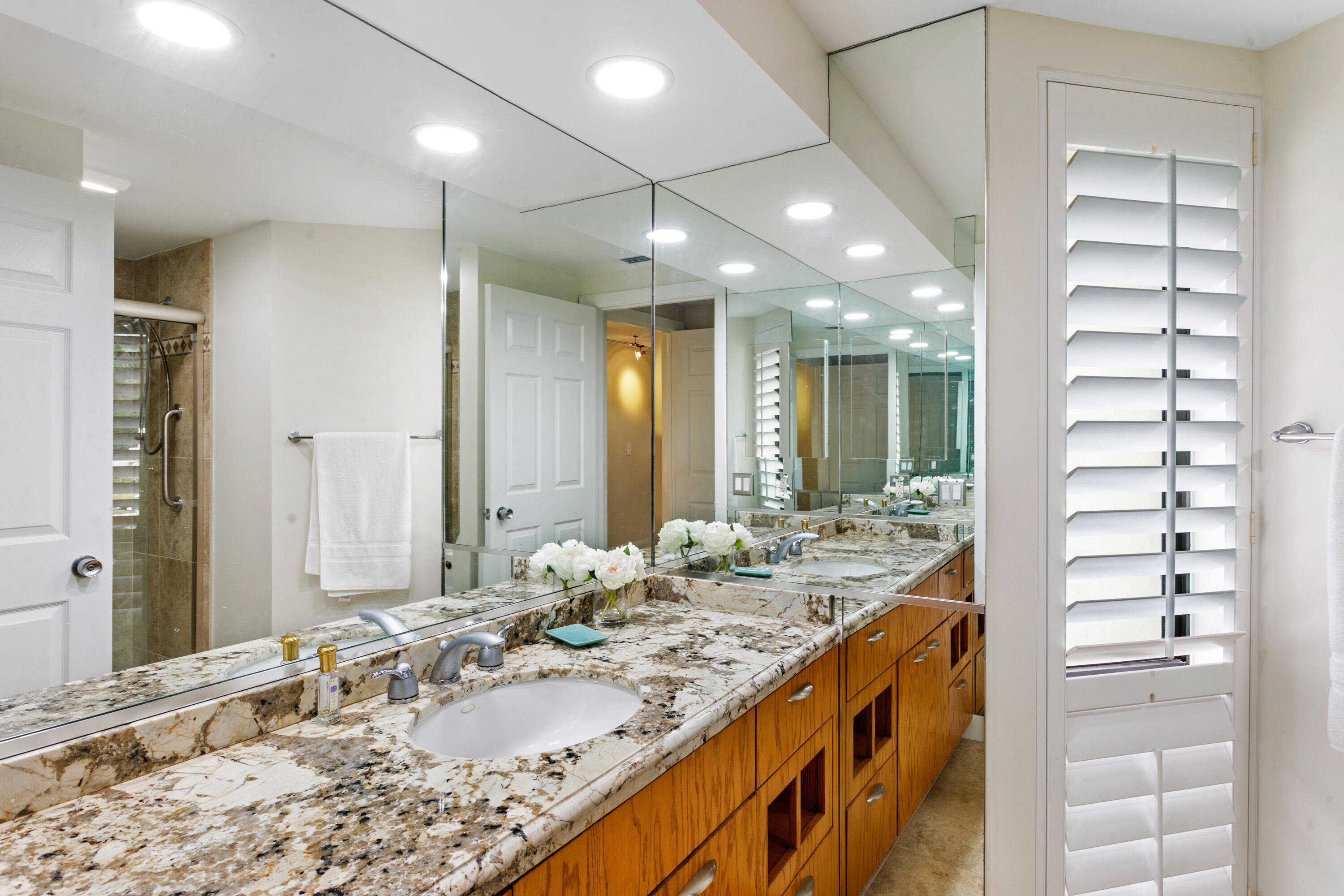 1109 Marine Way East, Unit L2R North Palm Beach, FL 33408 - Photo 18 of 27 a bathroom with a double vanity sink and a mirror