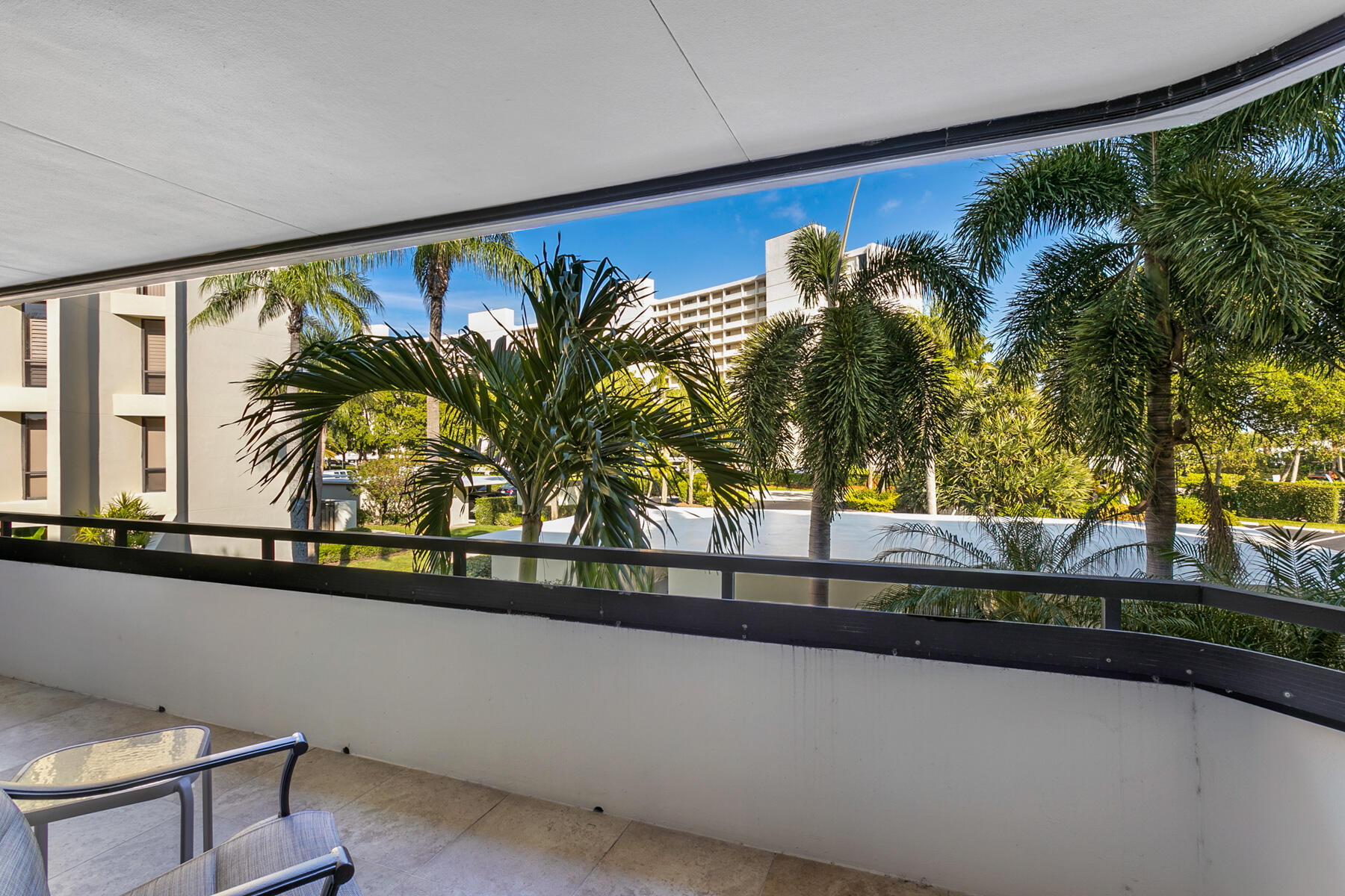 1109 Marine Way East, Unit L2R North Palm Beach, FL 33408 - Photo 9 of 27 a view of a living room with a floor to ceiling window and potted plants
