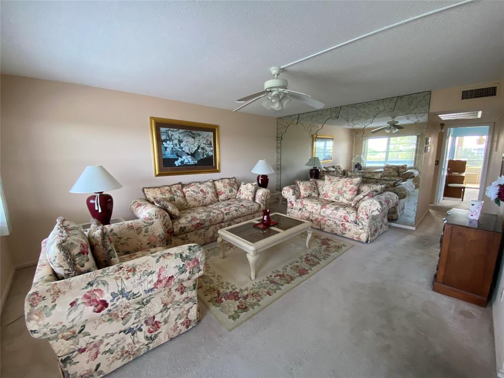4101 Oakridge V, Unit 4101 Deerfield Beach, FL 33442 - Photo 1 of 42 a living room with furniture and a couch