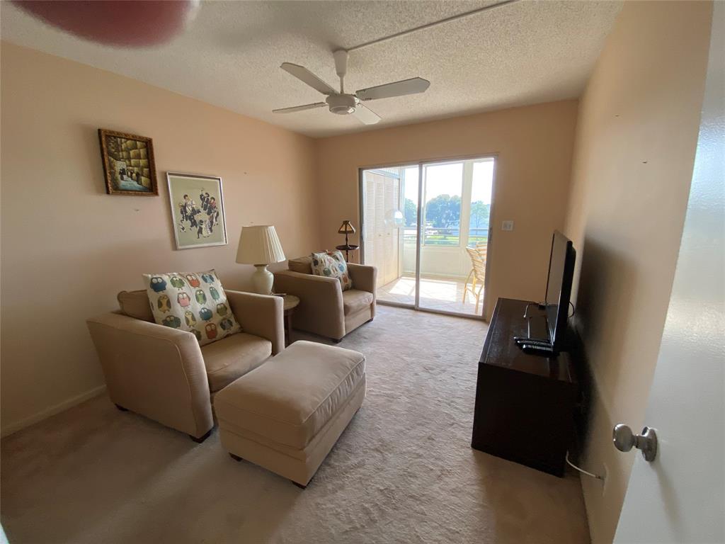 4101 Oakridge V, Unit 4101 Deerfield Beach, FL 33442 - Photo 15 of 42 a living room with furniture and a flat screen tv