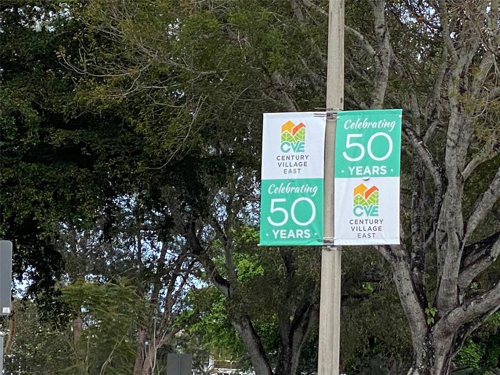 4101 Oakridge V, Unit 4101 Deerfield Beach, FL 33442 - Photo 23 of 42 a sign that is on a pole