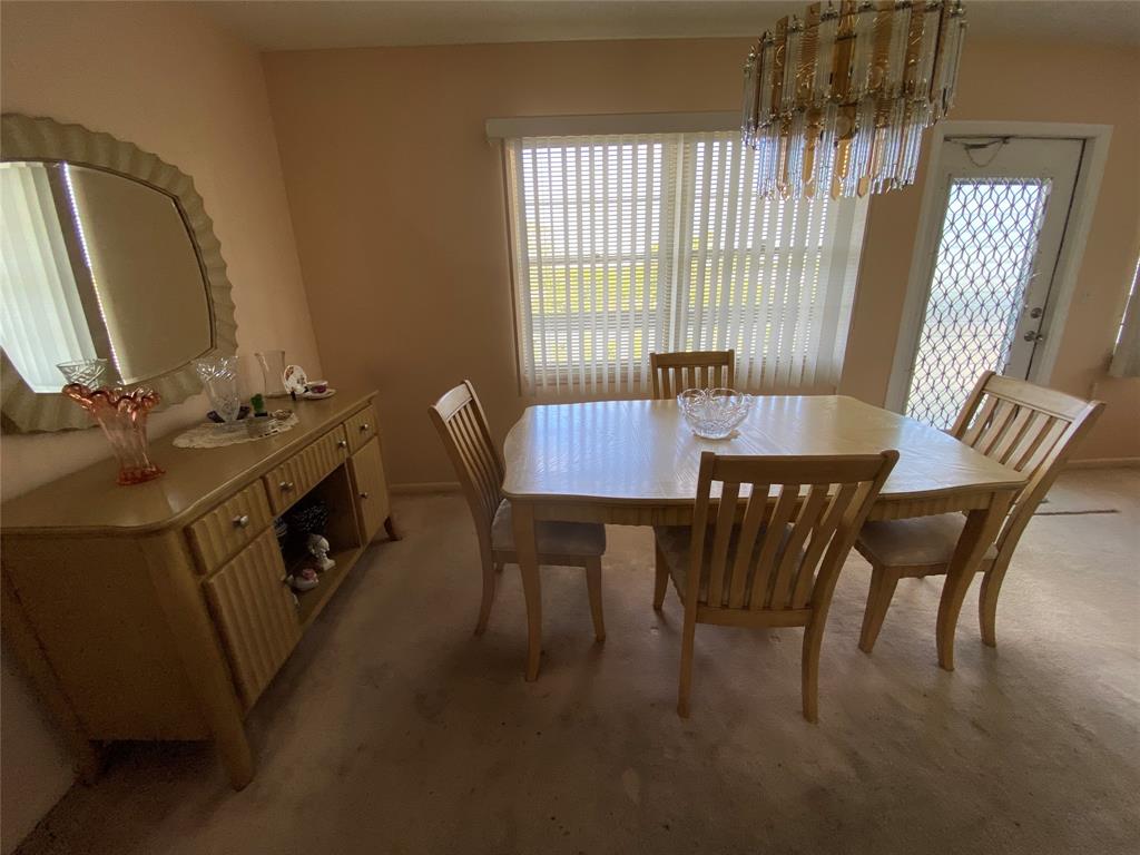 4101 Oakridge V, Unit 4101 Deerfield Beach, FL 33442 - Photo 7 of 42 a view of a dining room with furniture window and outside view