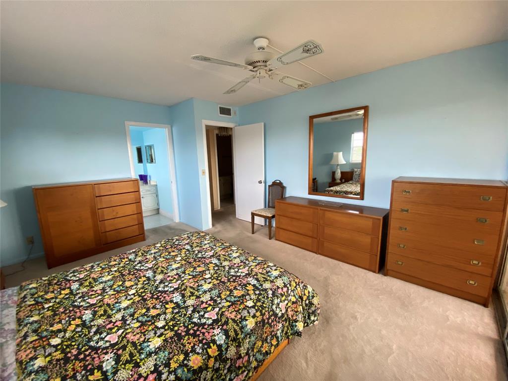 4101 Oakridge V, Unit 4101 Deerfield Beach, FL 33442 - Photo 10 of 42 a bedroom with a bed and dresser