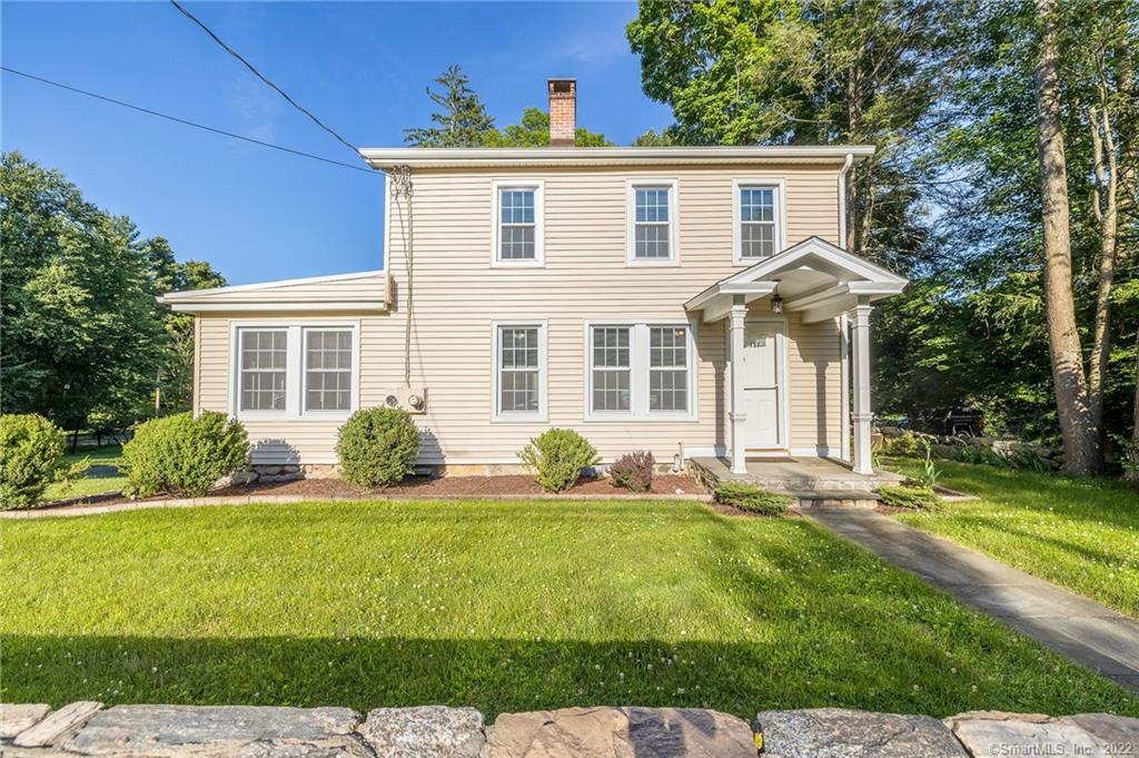 103 East Hunting Ridge Road Stamford, CT 06903 - Photo 1 of 1 a front view of a house with a yard