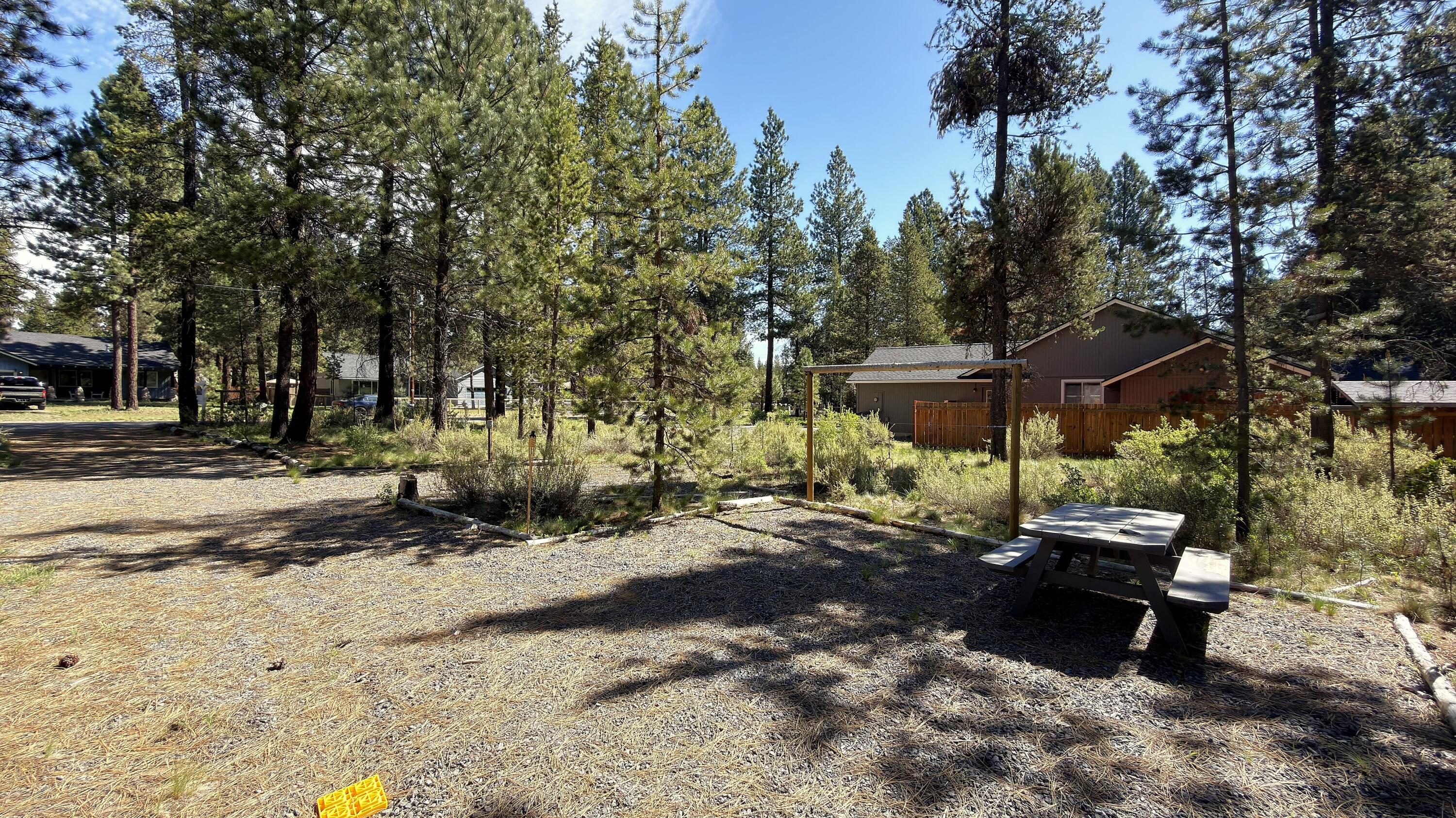 16999 Jacinto Road Bend, OR 97707 - Photo 19 of 38 a view of a park with a bench and trees
