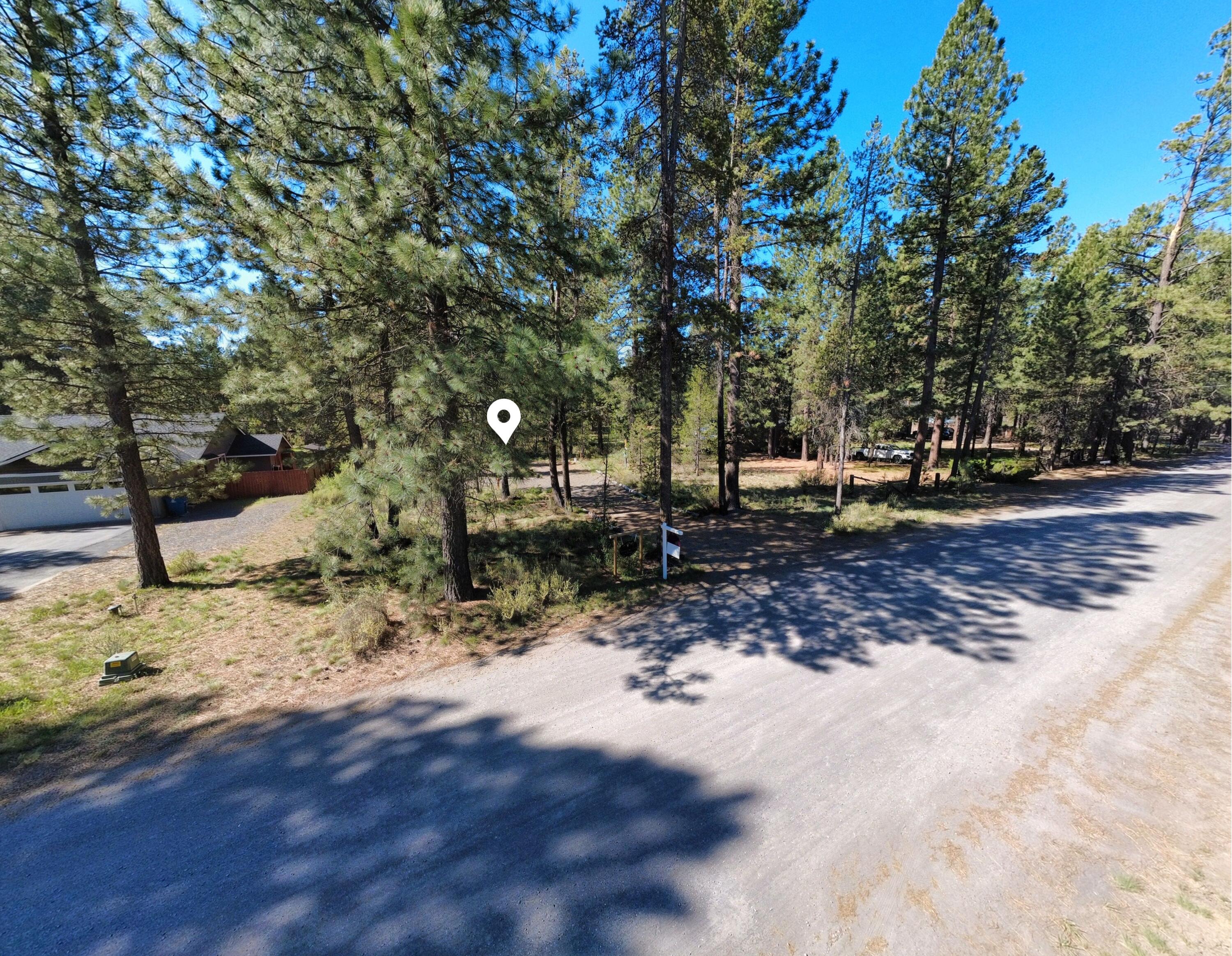 16999 Jacinto Road Bend, OR 97707 - Photo 24 of 38 a view of a yard with a tree