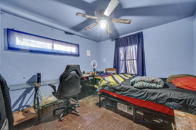 a bed room with a bed and a chair