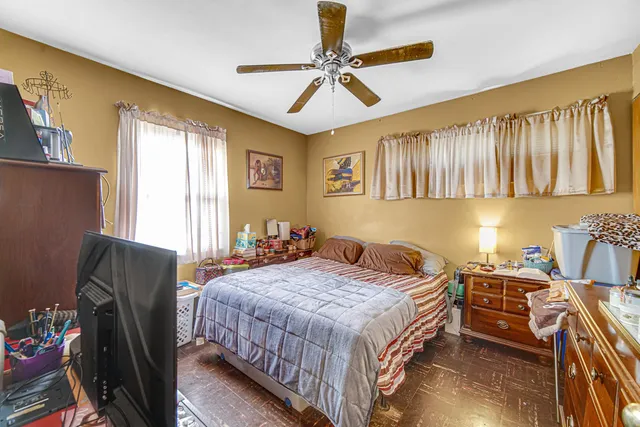 a bedroom with a bed dresser and a window