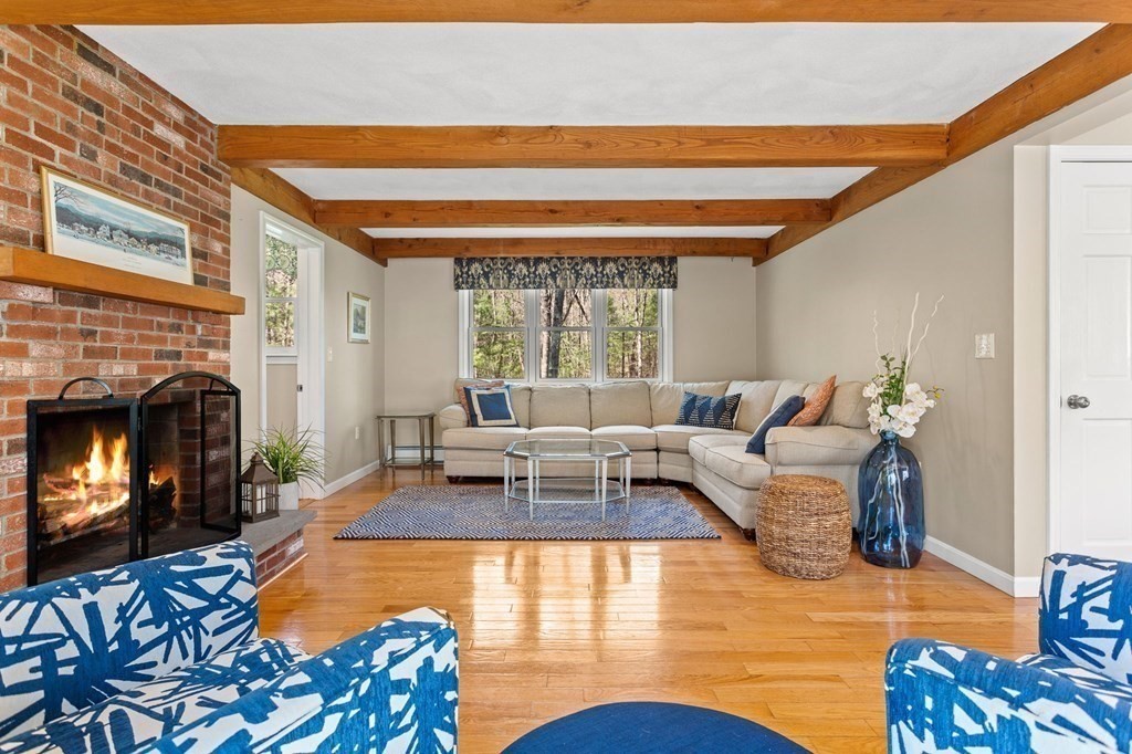 136 Leslie Road Rowley, MA 01969 - Photo 1 of 28 a living room with furniture fireplace and a large window